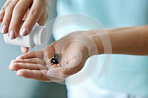 Medicine. Closeup Of Female Hand Pouring Pills Into Palm