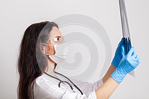 Medicine concept, female doctor examining mri of a patient brain in her office