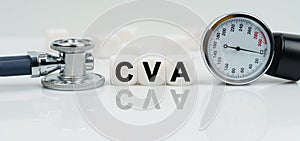 On a reflective white surface lies a stethoscope and cubes with the inscription - CVA photo