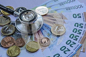 Medicine cost - Stethoscope over a stack of euros