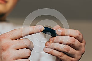 Medicine, diabetes, glycemia, healthcare and people concept - close up of a man`s hands using a lancet on his finger to check