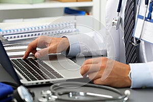 Medicine doctor hand press key on laptop computer keyboard