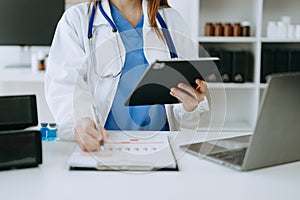 Medicine doctor hand working with modern digital tablet computer interface as medical network concept in office