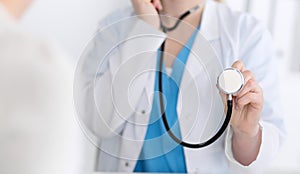 Medicine doctor hold stethoscope head closeup. Physician ready to examine and help patient. Medical help and insurance
