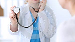 Medicine doctor hold stethoscope head closeup. Physician ready to examine and help patient. Medical help and insurance