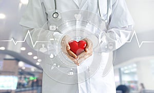 Medicine doctor holding red heart shape in hand and icon medical