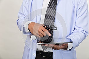 Medicine doctor holding stethoscope and working with modern tablet computer - Medical technology concept.
