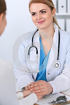 Medicine doctor reassuring her female patient. Medicine, comforting and trusting concept in health care