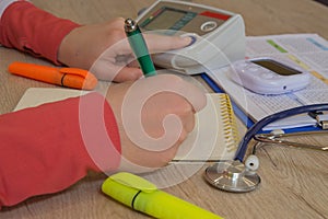 Medicine doctor`s working table. Medical concept. Doctor sits in a medical office in the clinic and writes medical history