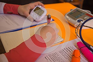 Medicine doctor`s working table. Medical concept. Doctor sits in a medical office in the clinic and writes medical history