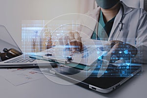 Medicine doctor touching on tablet and digital healthcare and network connection with modern virtual screen interface icons on the