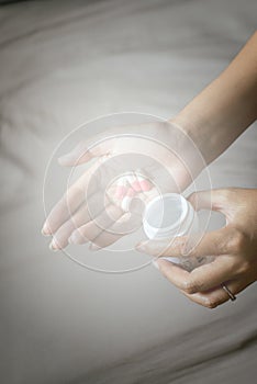 Medicine drug on hand,Woman hand with pills on spilling pills out of bottle