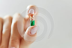 Medicine. Female Hand Holding Colorful Pill, Tablet