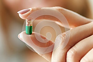 Medicine. Female Hand Holding Colorful Pill, Tablet