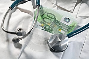 Doctor coat with stethoscope and money