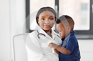 Doctor or pediatrician with baby patient at clinic