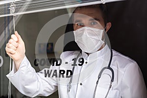 Medicine and health care concept. Man doctor in hospital. Doctor wearing protective mask checking and take care infected