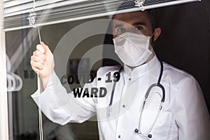 Medicine and health care concept. Man doctor in hospital. Doctor wearing protective mask checking and take care infected