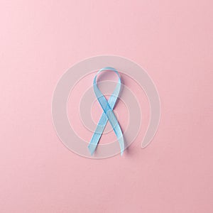Medicine, health care and symbolics concept - close up of blue prostate cancer awareness ribbon photo