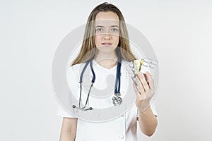 Medicine and health concept. Doctor woman holds pills in hands
