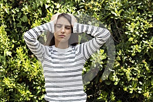 Medicine and Health Concept - Young woman with a headache