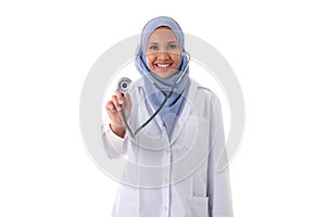 Medicine, healthcare, charity and people concept - portrait of friendly smiling muslim female doctor dressed in uniform