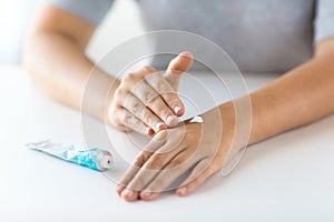Close up of hands with cream or therapeutic salve photo