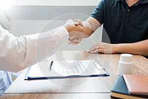 Medicine healthcare and trust concept, doctor shaking hands with patient colleague after talking about medical examination results