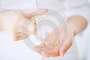 Medicine herb. Herbal pills in hand, palm, fingers with healthy medical plant. Vitamin supplement for care, medication