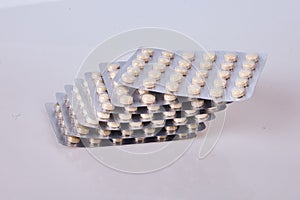 Medicine herbal pills or tablets in silver blisters on white background.