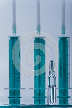 Medicine, Injection, vaccine and disposable syringe, drug concept. Sterile vial medical syringe needle. Glass medical