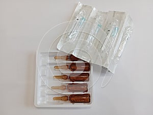 Medicine, Injection, vaccine and disposable syringe, drug concept. Sterile vial medical syringe needle. Macro close up.