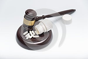 Medicine law concept. Gavel, stethoscope and pills isolated on white.