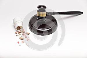 Medicine law concept. Gavel, stethoscope and pills isolated on white.