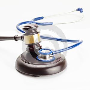 Medicine and medical symbols - close up shot of a judge gavel and a stethoscope