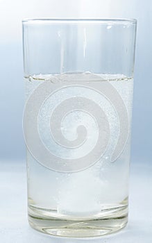 Medicine pill or vitamin dissolving in water.