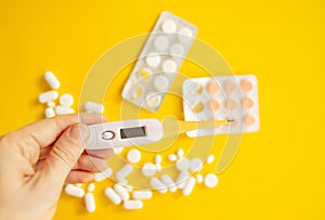 medicine pills, antibiotic tablets on a yellow background, treatment of colds and illnesses