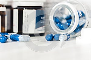 Medicine pills or capsules and bottles on white background with copy space. Drug prescription for treatment medication closeup top