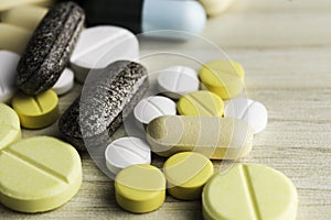 Medicine pills or capsules on wood background.Drug prescription for treatment medication.