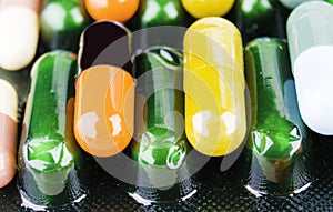 Medicine pills or capsules on wood background.Drug prescription for treatment medication.