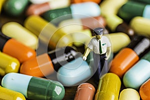 Medicine pills or capsules on wood background.Drug prescription for treatment medication.Pharmaceutical medicament.