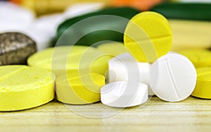 Medicine pills or capsules on wood background.Drug prescription for treatment medication.Pharmaceutical medicament.