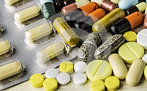 Medicine pills or capsules on wood background.Drug prescription for treatment medication.Pharmaceutical medicament.