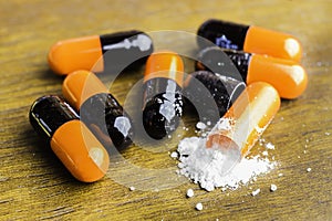 Medicine pills or capsules on wood background.Drug prescription for treatment medication.Pharmaceutical medicament,cure for health
