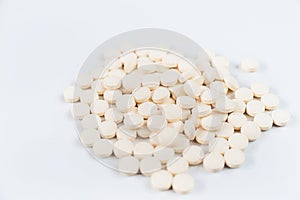 Medicine pills concept on gray background. A lot of round pills on a white background close-up and copy space