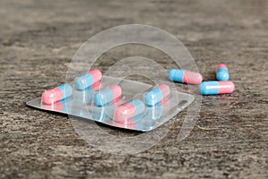 Medicine pills on a light background. Medicines and prescription pills flat lay background. Blue and pink medical