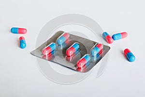 Medicine pills on a light background. Medicines and prescription pills flat lay background. Blue and pink medical