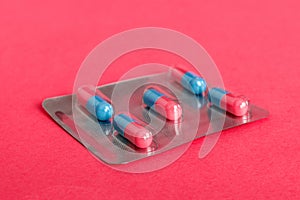 Medicine pills on a light background. Medicines and prescription pills flat lay background. Blue and pink medical