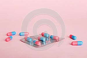 Medicine pills on a light background. Medicines and prescription pills flat lay background. Blue and pink medical