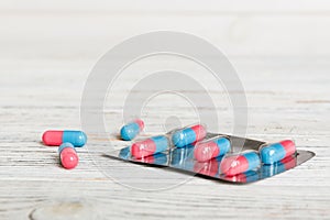 Medicine pills on a light background. Medicines and prescription pills flat lay background. Blue and pink medical